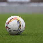 Soccer field with artificial turf and natural grass sections